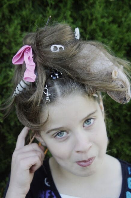 Girl with a rats nest hairdo poses for the camera